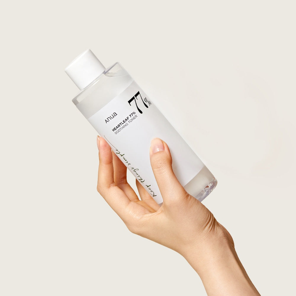 Anua Heartleaf 77% Soothing Toner applied with a cotton pad