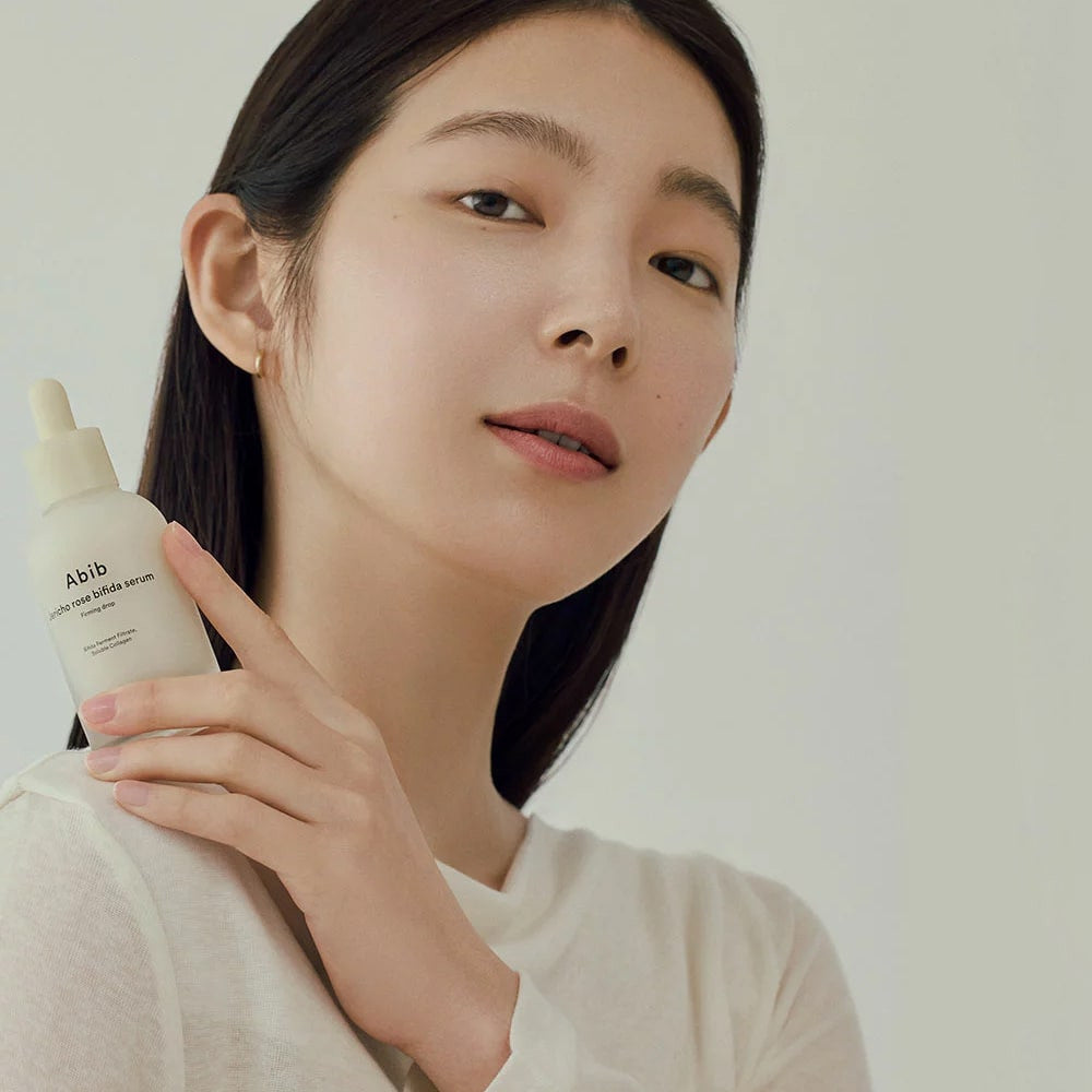 Model holding Abib Jericho Rose Bifida Serum Firming Drop 50 ml bottle
