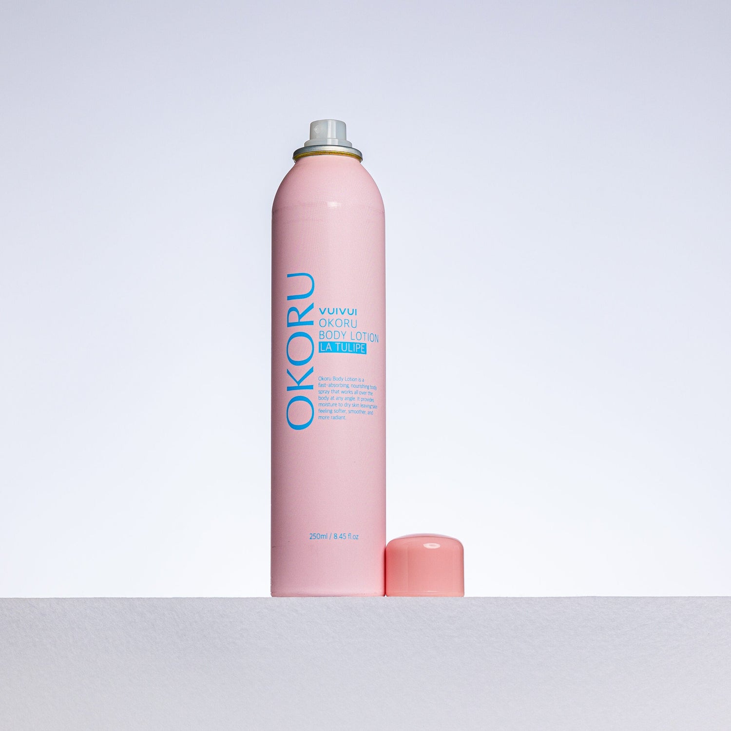 OKORU La Tulipe spray body lotion shown being misted onto skin