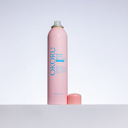 OKORU La Tulipe spray body lotion shown being misted onto skin