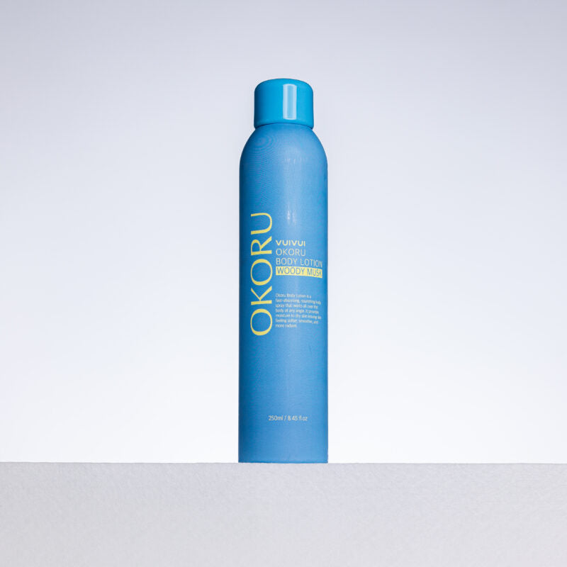 OKORU Woody Musk body lotion spray bottle on white background