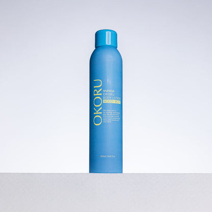 OKORU Woody Musk body lotion spray bottle on white background