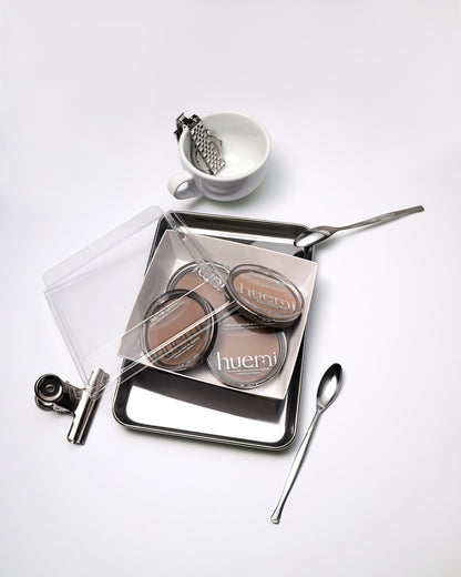 HUEMI Triple Contour Shading palette with a makeup brush