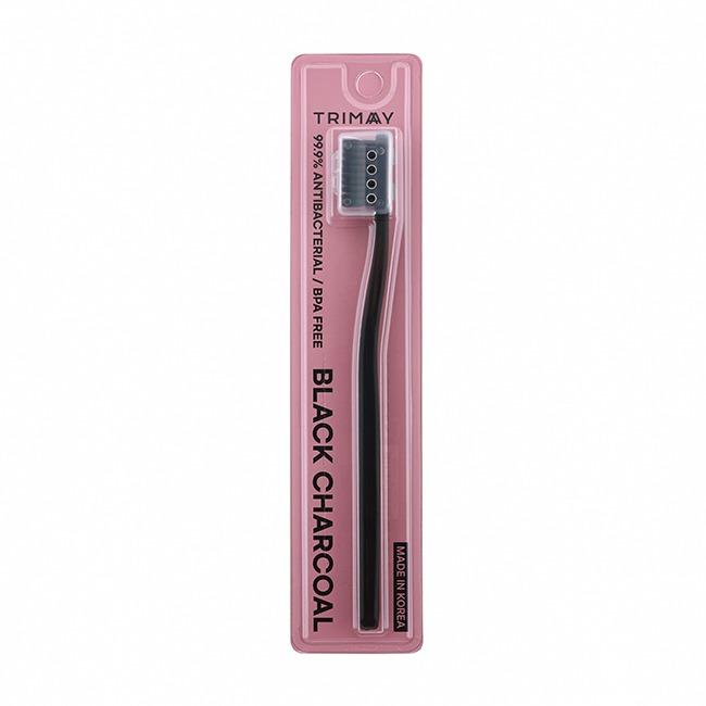 A close-up of the Trimay Black Charcoal Toothbrush with its distinctive black bristles.