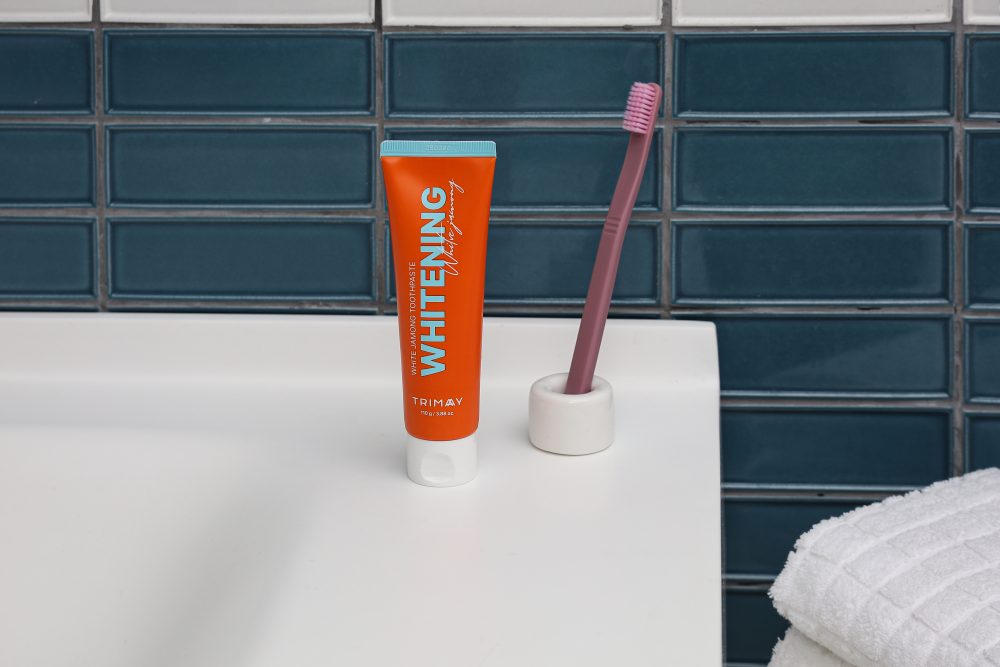 Trimay Whitening White Jamong Tooth Paste in a bathroom setting